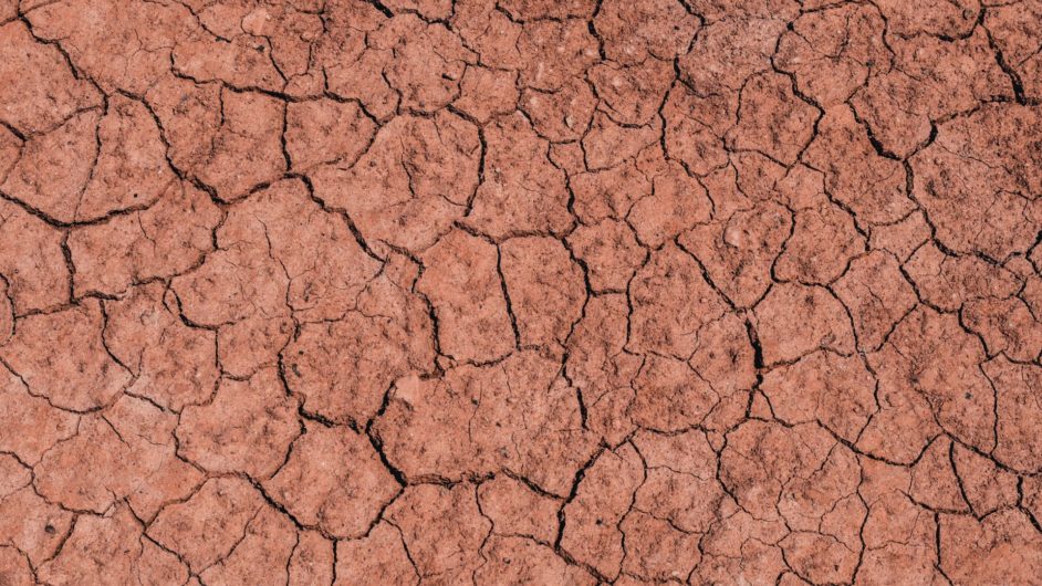 Aerial view of brown ground with many cracks across its surface